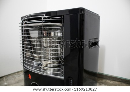 Black kerosene heater in a white background composition