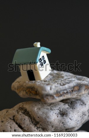 house on the edge of the abyss on a black background. The concept of a dangerous situation in life and critical grievances. the concept of a catastrophe and a critical situation