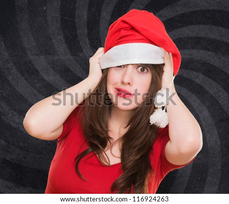 worried woman wearing a christmas hat against a vintage background