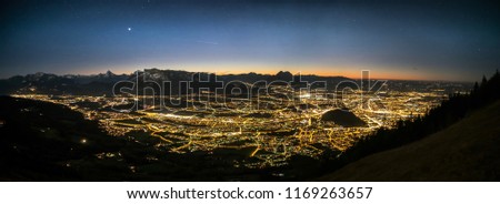 a wide angle panorama of salzburg by night, shot from mt. gaisberg