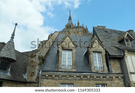 The roofs of the old city against the background of the fortress of Mont Saint Michel, Normandy, France
