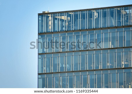 Abstract fragment of contemporary architecture, walls made of glass and concrete. Glass curtain wall of modern office building
