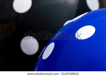 Background blue and black balloons with the white circles on them. The optimistic picture, the symbol of happiness and joy