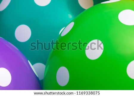 Background of green and purple balloons with the white circles on them. The optimistic picture, the symbol of happiness and joy