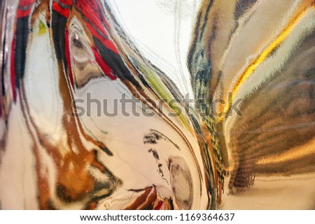Colorful free flow lines reflected from the twisted metal sheet. This is blurred photography.