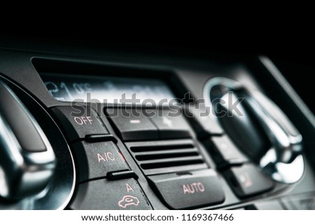 Air conditioning button inside a car. Climate control AC unit in the new car. Modern car interior details. Car detailing.