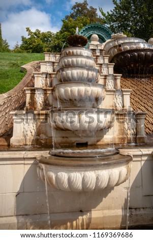 Beautiful fountain on a sunny summer day. Details from Dutch baroque garden with running water, shapes of sea shells and mythological antique white-marble statues