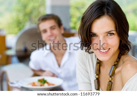 A young couple on vacation eating lunch at a relaxed outdoor restaurant Royalty-Free Stock Photo #11693779