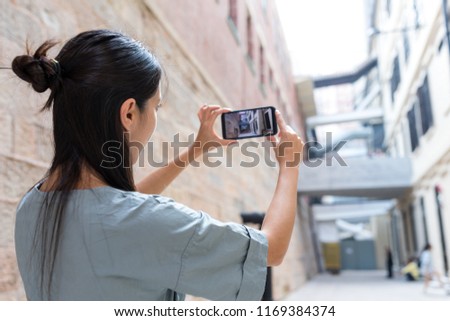 Woman taking photo on mbile phone