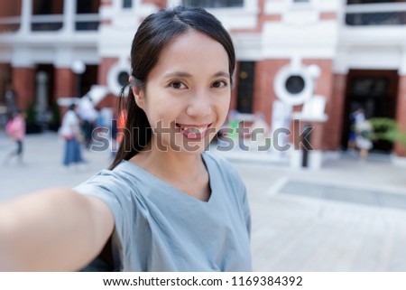 Woman taking photo with cellphone in the city