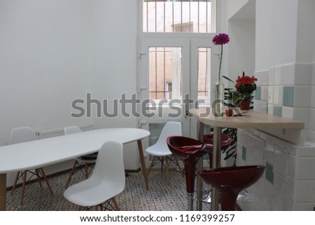 white kitchen dining room with red and white chairs