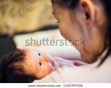 Mother and her sweet baby in the room at home