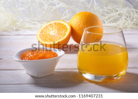 Orange jam and juice in glass. Morning breakfast.