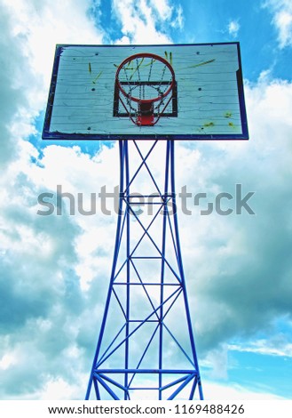 The game could begin. Basketball hoop  above outdoor playground  with sky in the background 