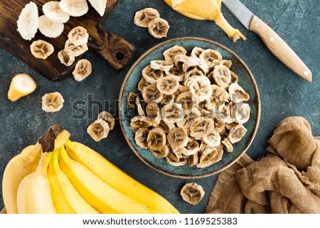 Dried banana chips and fresh bananas