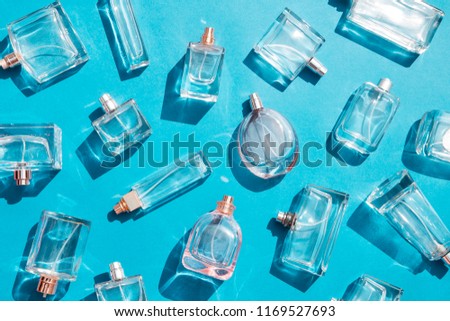 Perfume bottles on blue background Royalty-Free Stock Photo #1169527693