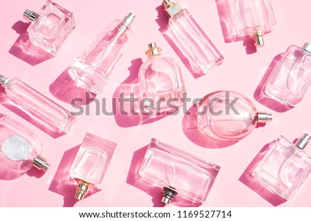 Perfume bottles on pink background Royalty-Free Stock Photo #1169527714