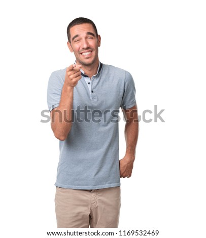 Funny young man laughing and pointing you