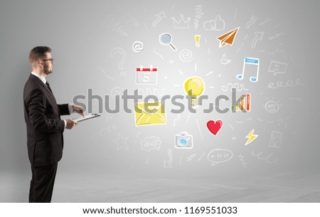 Young manager presenting new plan  illustrated by colourful chalk drawn icons and symbols around