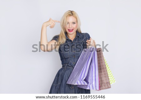 Blond woman with shopping bags in her hands