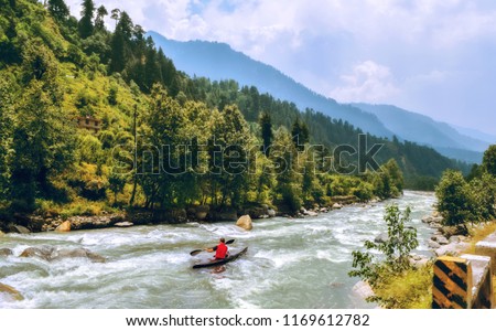 Tourist enjoy river rafting on Beas river with scenic landscape at Manali Himachal Pradesh, India. Royalty-Free Stock Photo #1169612782