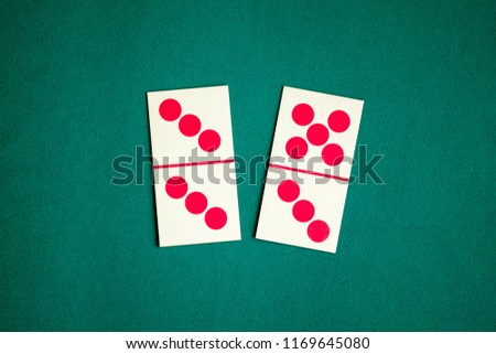 Dominoes playing card on green color table