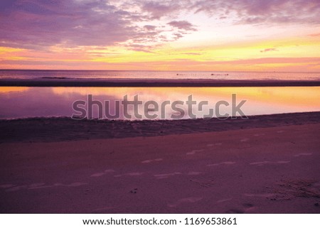 tourism concept picture of summer sunset over sand beach with reflection in Thailand