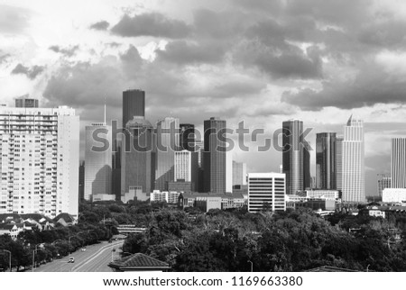 An approaching storm looms in front of the downtown Houston skyline.