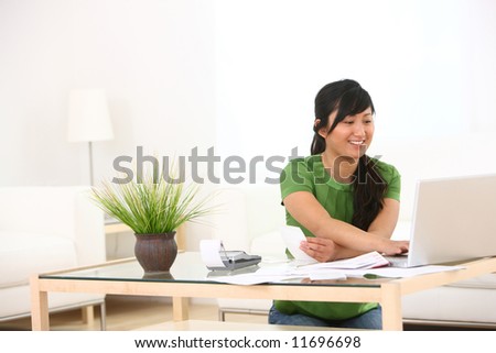 Young woman in living room with paperwork