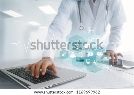 Medicine doctor hand touching laptop and tablet interface as medical network connection with icon modern on virtual screen, Digital healthcare, medical technology network and innovation concept