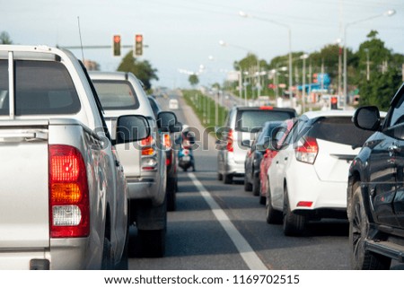 Cars break on the road by traffic jam on day to travel.