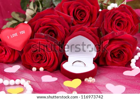 Beautiful bouquet of roses on pink fabric close-up