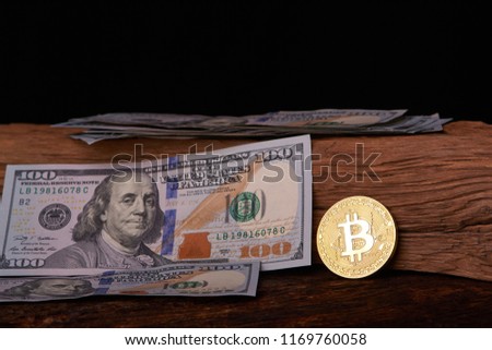 Golden metal bitcoin on dollar bills background. a lot of money in cash. 100 dollars texture. dear bitcoin. Gold coin. Profit from mining