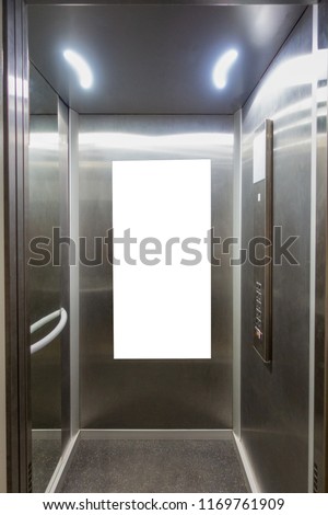 Mock up. Vertical poster media template frame hanging on the wall in elevator lift