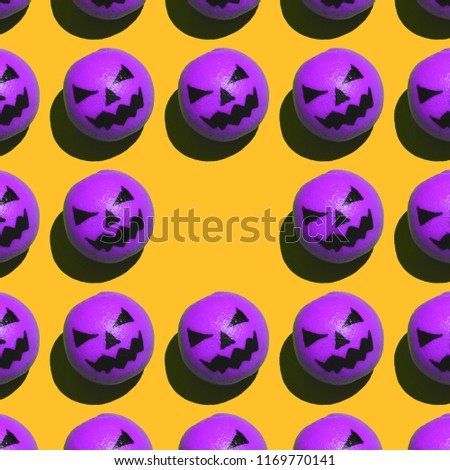 spooky purple pumpkins on orange background with empty space for text in the middle. Halloween style