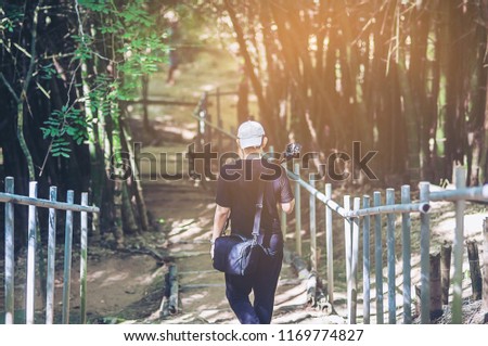 photographer traveling in the nature forest for beautiful pictures 