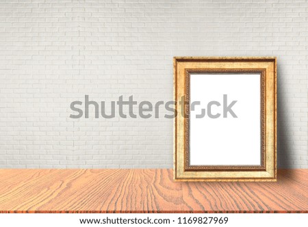 Close up blank picture frame put on table with brick wall background use for text or product display