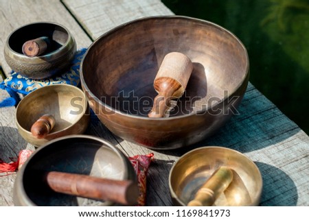 Tibetan bowls on a wood floor in a park