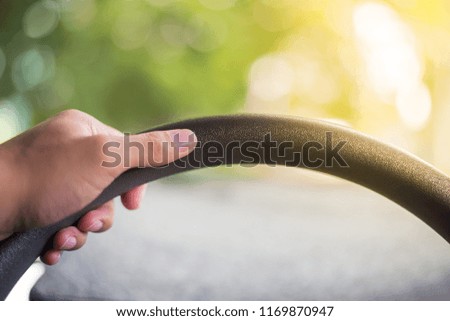 Driver's hands on the steering wheel inside of a car with vintage tone nature and blurry bokeh background  