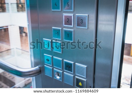Elevator buttons control panel in modern business building or Mall or shopping center, close up, toned