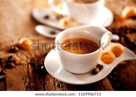 A cup of espresso coffee on a dark wooden background. Top view. Free space for text.