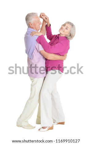 Portrait of a senior couple dancing on white background