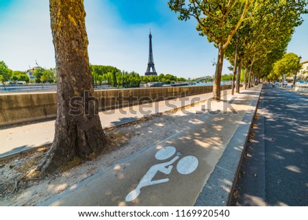 Bike lane by Seine river with world famous Tour Eiffel on the background. Paris, France