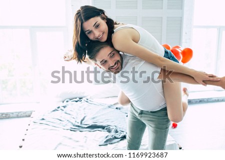 Funny and happy young cute smiling beautiful couple spend time together, they are dancing, playing and have a fun with each other. Love, relationships, family and St. Valentine's day