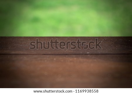 empty template of a wooden surface on a background of greenery