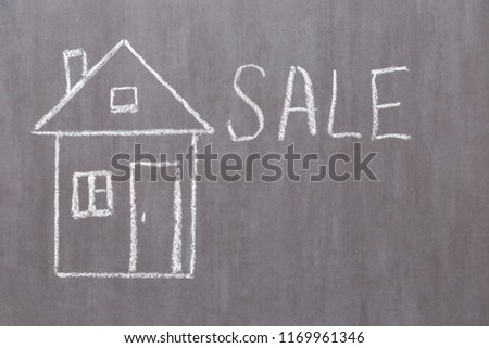 House, drawn with chalk on a gray board and free background for text