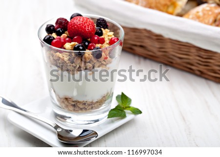 yogurt with muesli and berries in small glass Royalty-Free Stock Photo #116997034