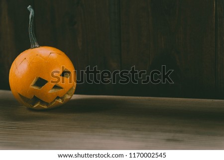 Closeup Photo of Carved Baby Pumpkin on the Wodden Background