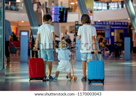 Children, traveling together, waiting at the airport to board the aircraft