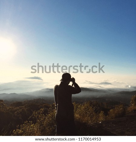 The tourist take a photo of the mist on the mountain peak in Chiang Mai, Thailand